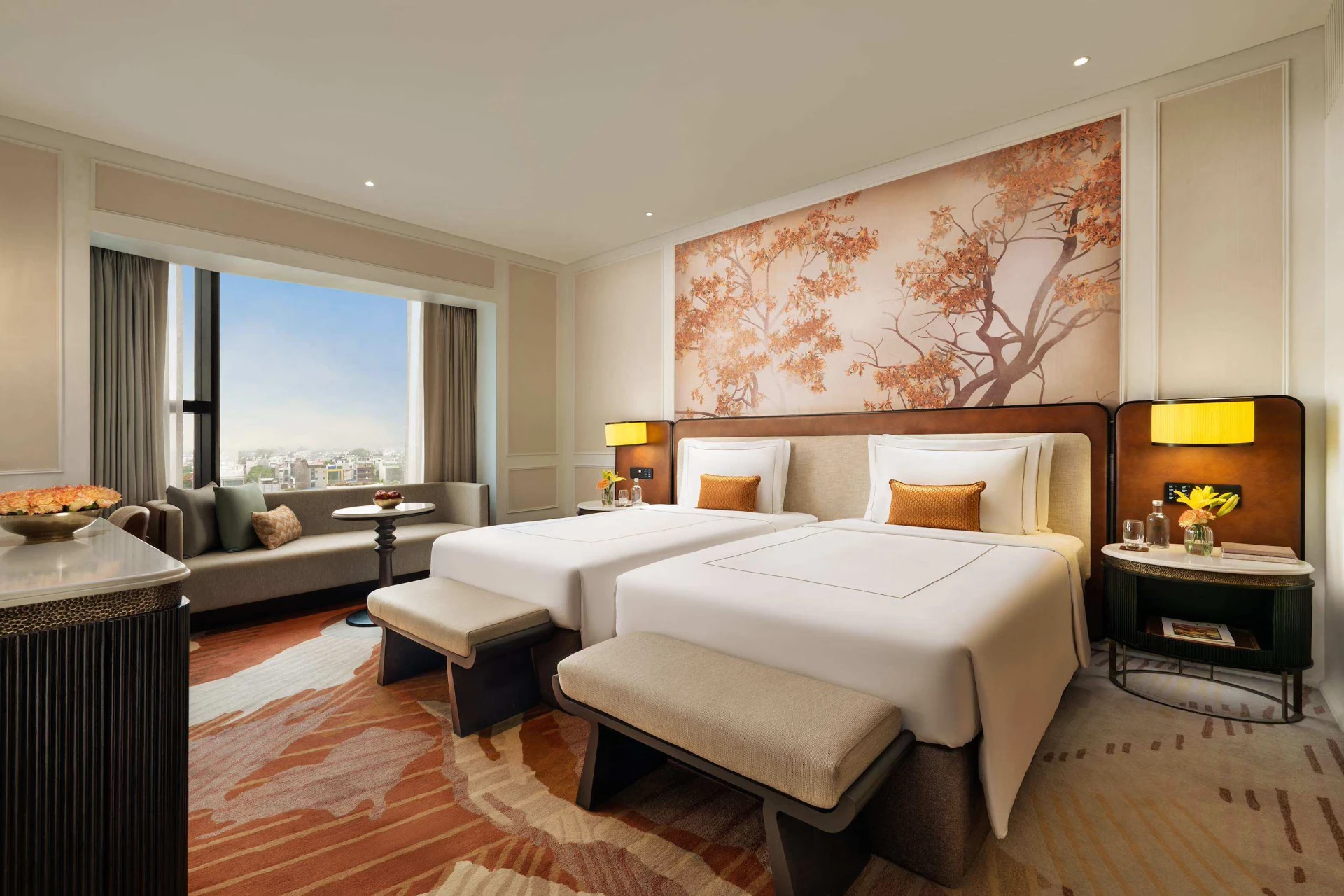 Twin guest room with two beds and a window-side seating area