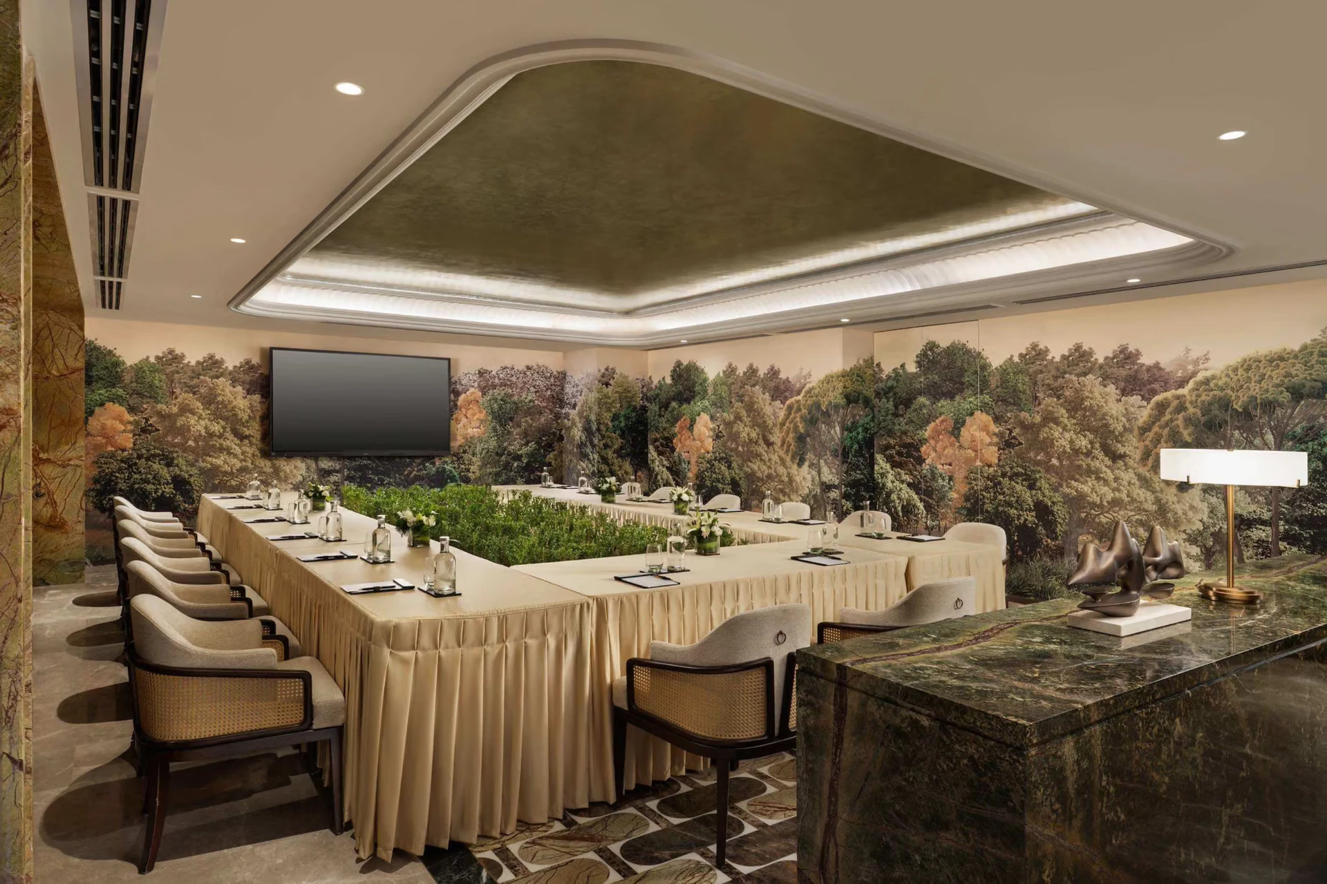 Elegant meeting room with a long dressed table and botanical wall panels